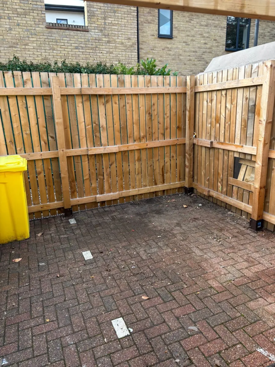 After: Bin store rubbish clearance: overflowing bags and boxes removed, floor left swept