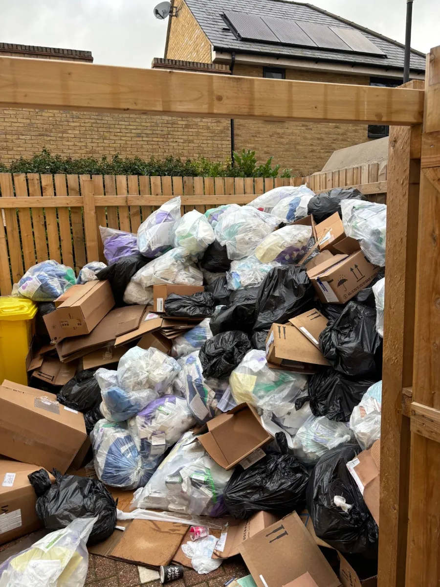 Before: Bin store rubbish clearance: overflowing bags and boxes removed, floor left swept